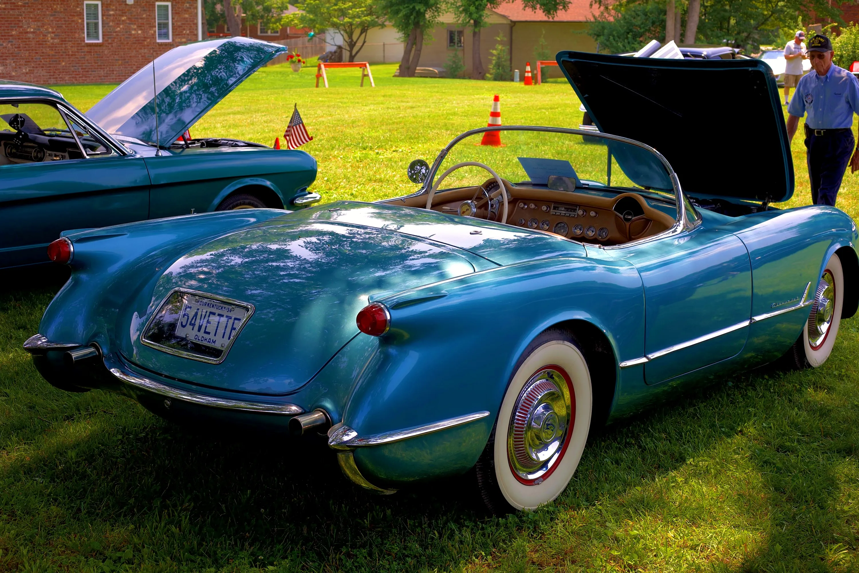 Display portrait — a rear three-quarter view captures the presentation, open cabin and surrounding show atmosphere.