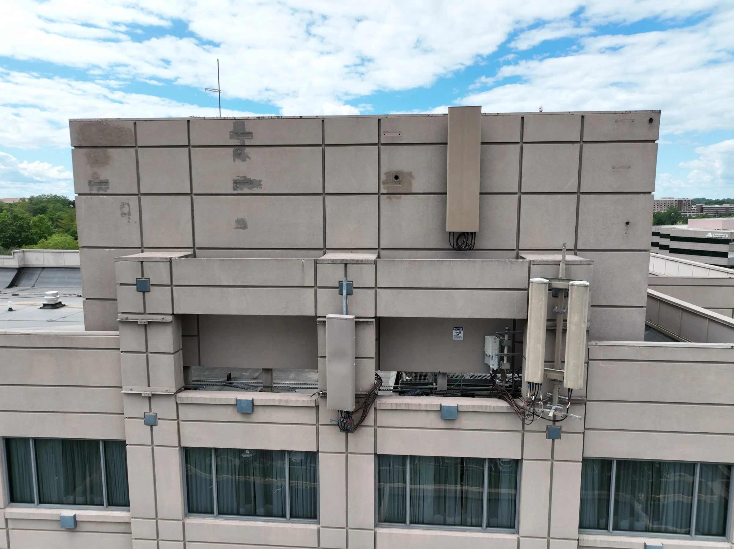 Building-mounted installation — frontal coverage establishes the full antenna layout and routing path.